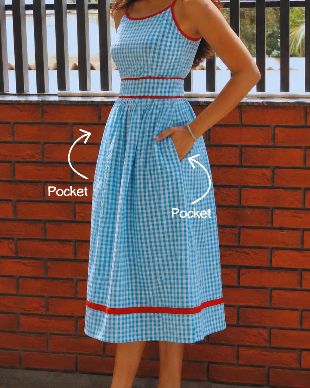 Close-up of pockets on the gingham dress
