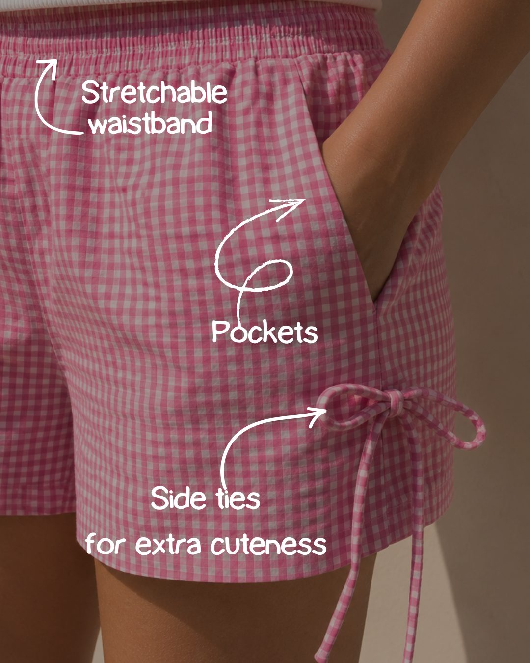 Close-up of stretchable waistband and side ties on the pink shorts